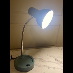 Flexible, blue desktop lamp.